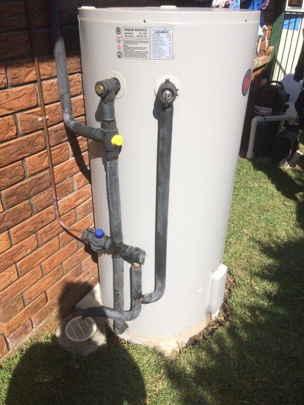 Outdoor water heater connections and valves installation in Brisbane home