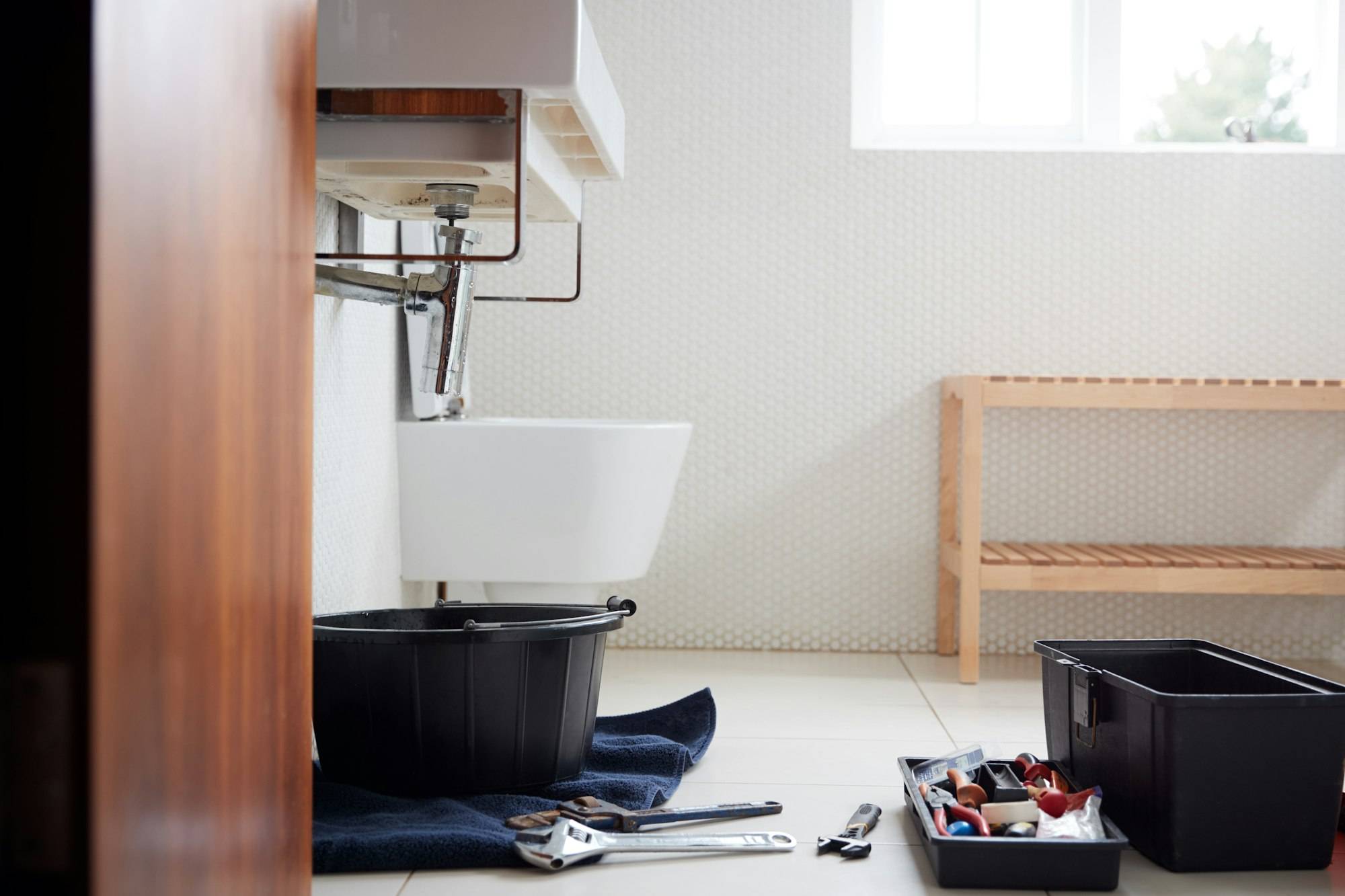 a bathroom with tools on the floor